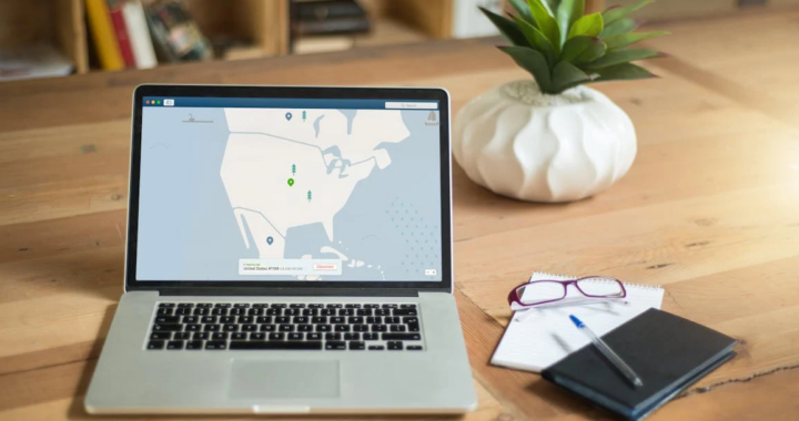 An image of a laptop and notebook on a table