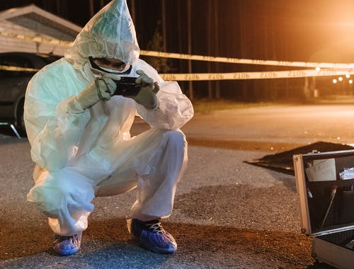 A forensic expert examining a crime scene 