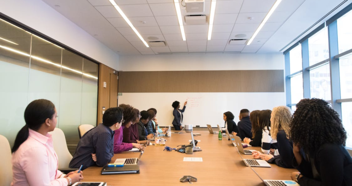 A group of employees in a conference room during a meeting