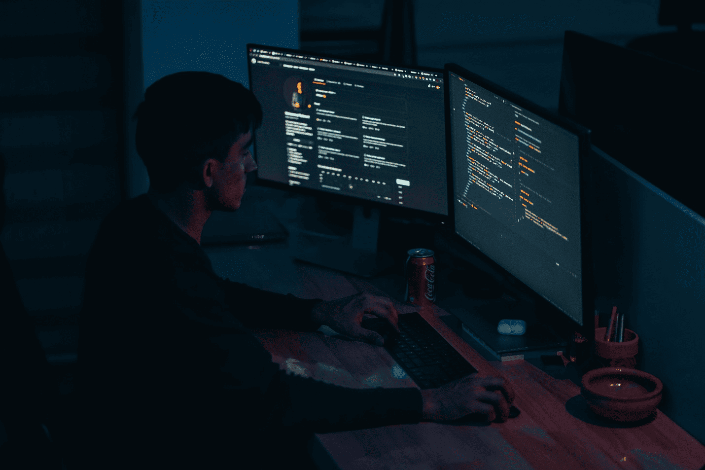: A guy coding on his computer