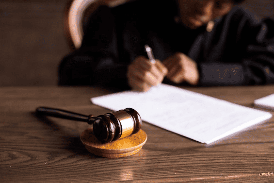 A judge signing a paper