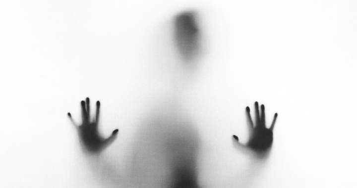 An image of a person behind a fog glass
