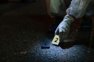 A forensic investigator marking a piece of evidence