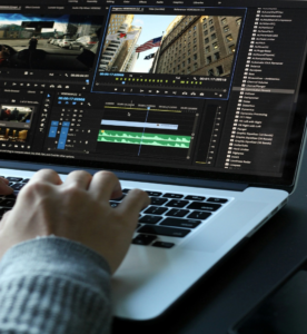 A person using a laptop computer to examine audio and video files.