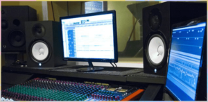 A workstation equipped with advanced audio analysis tools, including monitors displaying audio waveforms and professional-grade speakers, used by forensic audio specialists to ensure precise and reliable results.