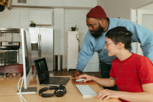 Two forensic experts collaborating and discussing future trends and advancements in video timestamp analysis using a computer.