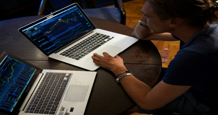 A forensic expert working on two laptops