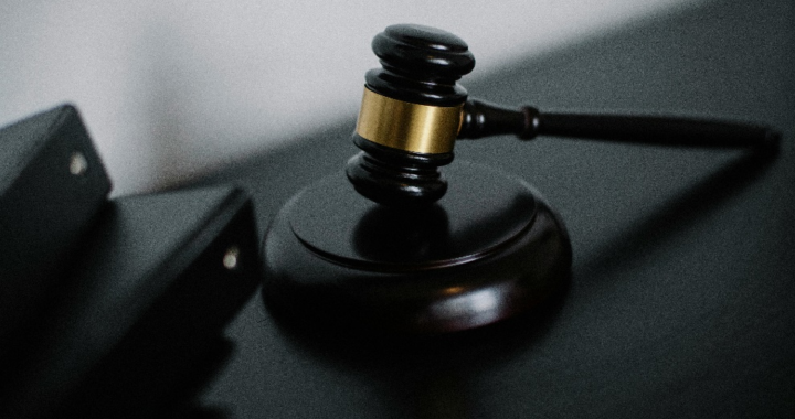 A gavel resting on a wooden block