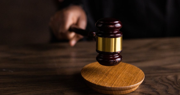 A gavel resting on a wooden block