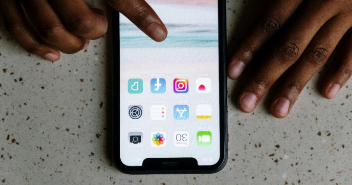 Person touching a phone’s screen