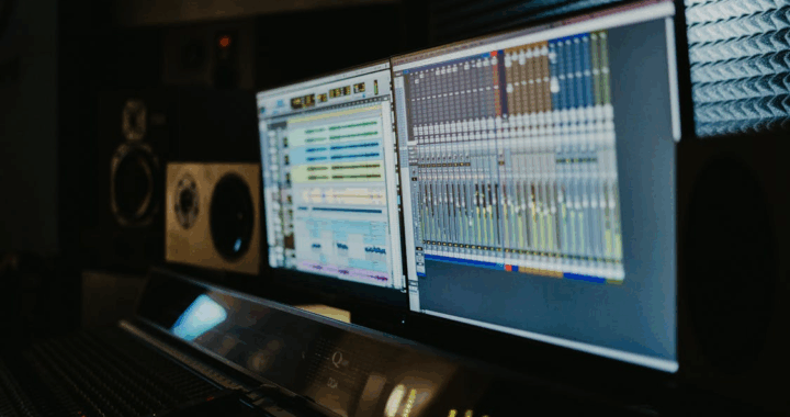 close-up of a forensic audio editing setup with two screens