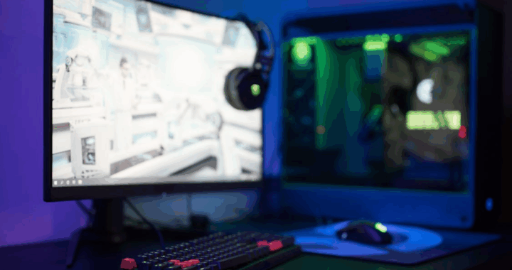 a computer screen with headphones on it, placed in a dark room