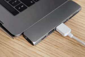close-up of a MacBook connected to an external device