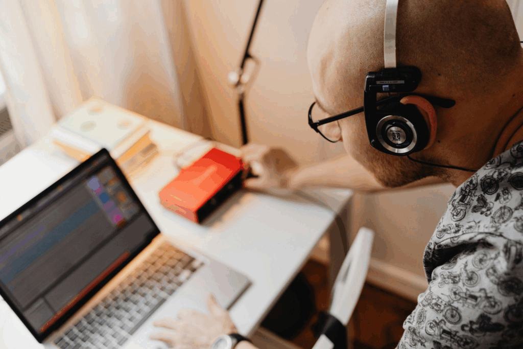 a man listening to an audio recording through headphones