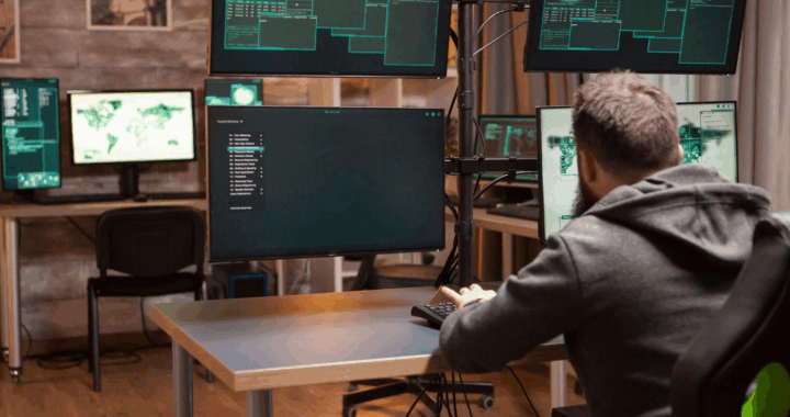 a man converting files on a multi-screen setup