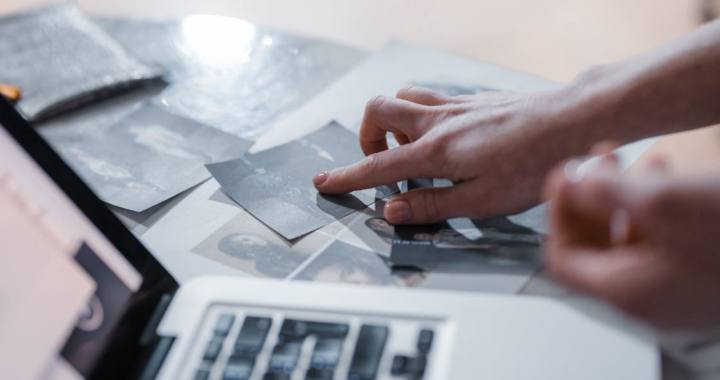 close-up of a person going through digital evidence and crime scene photos side by side