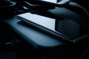 Smartphone resting on a dark desk