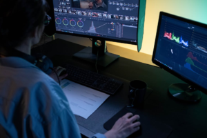 Analyst reviewing video on two monitors with color and brightness controls