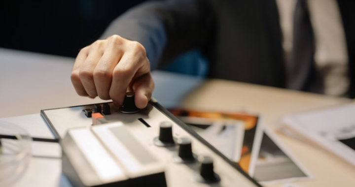 Professional adjusting controls on an audio workstation.