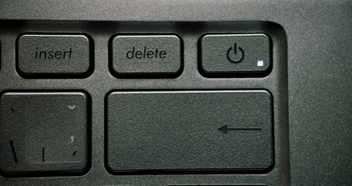 Close-up of a laptop keyboard showing the delete and power keys.